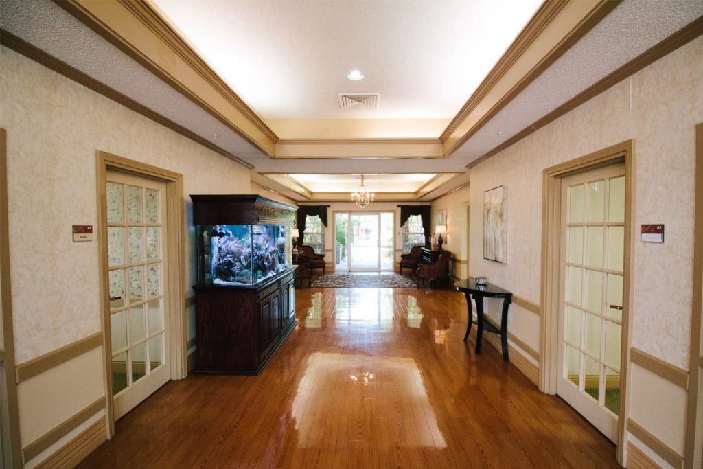 A hallway with an aquarium at a long term care, short term care, respite care facility