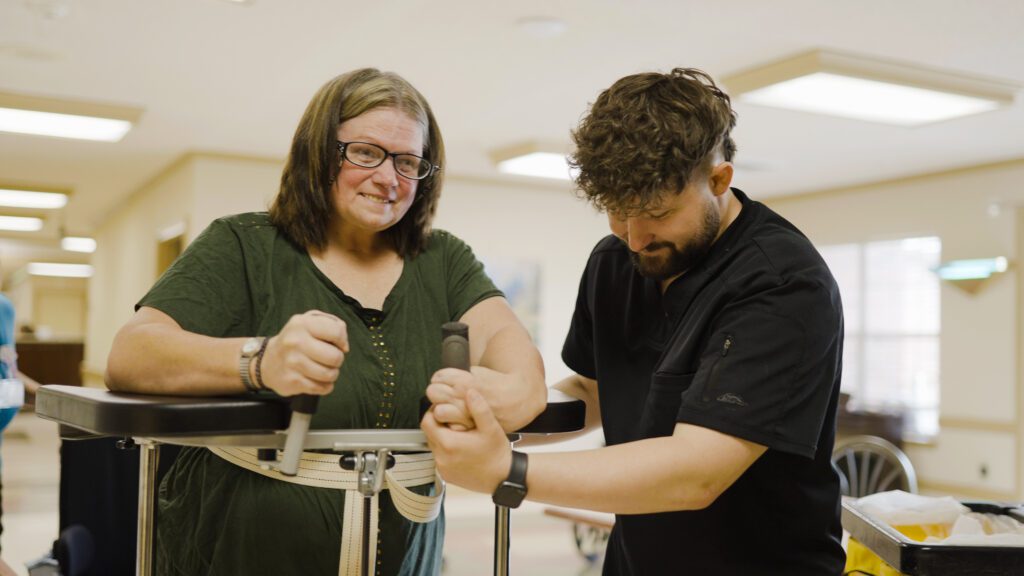A woman in physical therapy smiling in short term care